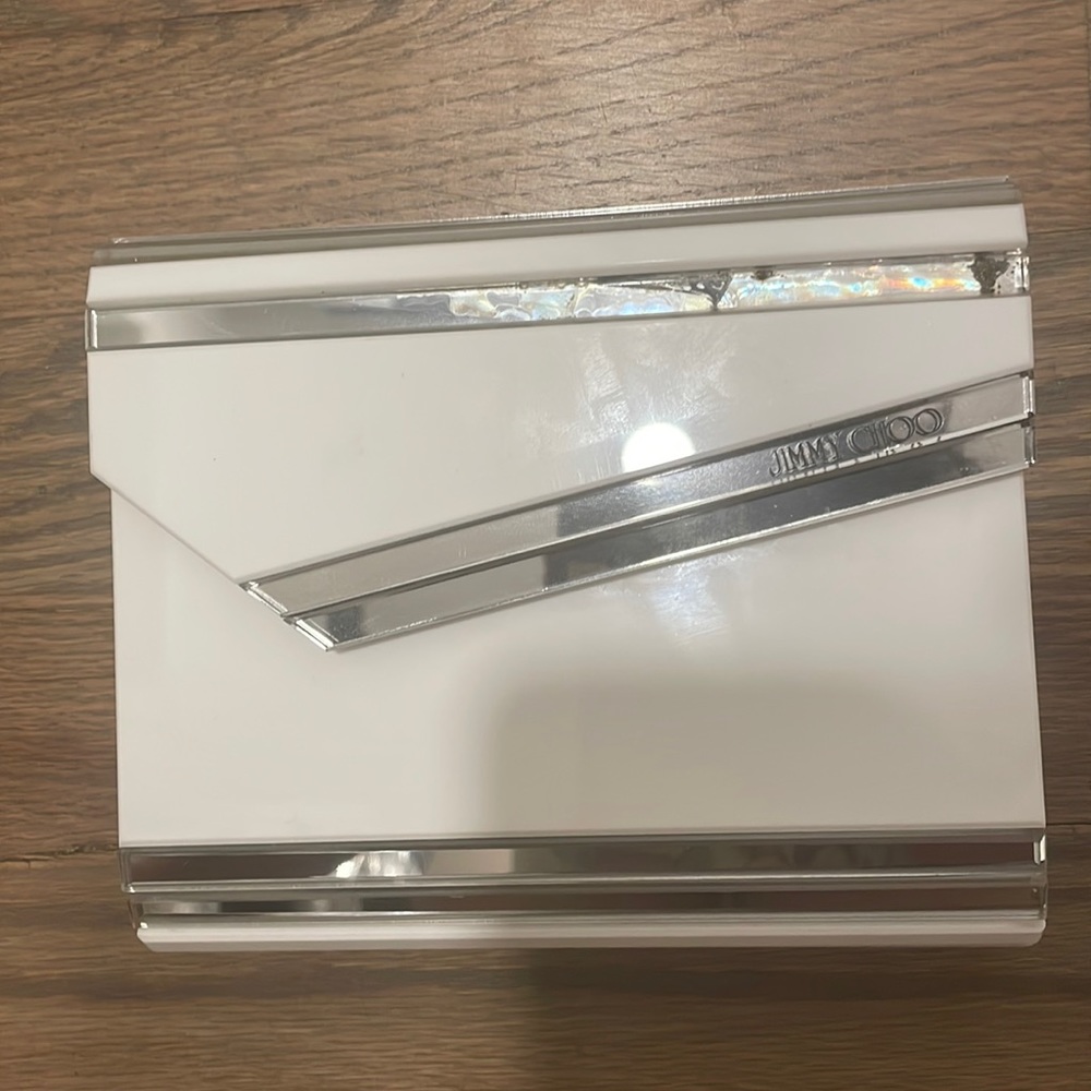 Jimmy choo candy clutch with chain. It has a minor damage as shown in pics.